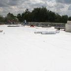 ANC Roofing employees working on a flat roof