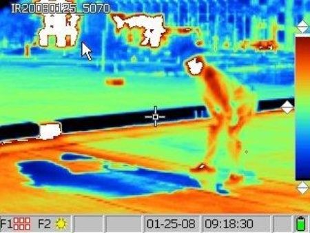 infrared image of an employee working on a flat rooftop