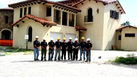 ANC Roofing team outside a home with tile roofing
