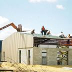 ANC roofers installing a metal roof onto a warehouse