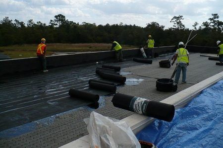 ANC Roofing workers installing a flat rooftop