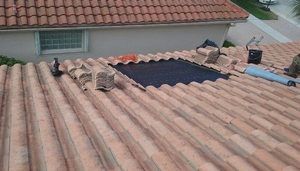A tile roof getting repaired by ANC Roofing Inc. in Winter Garden, FL