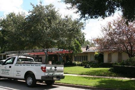 ANC Roofing truck outside of a residential home