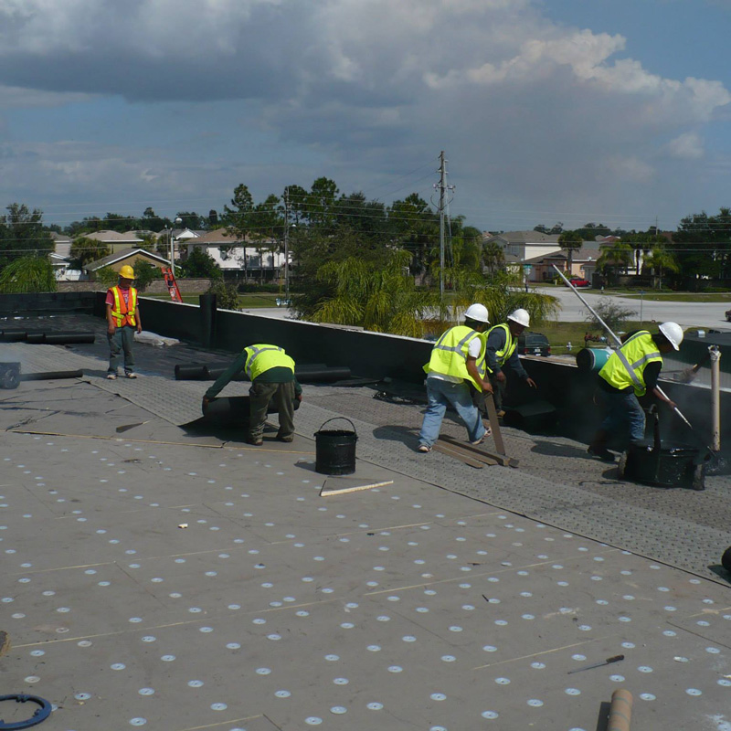 men working on a flat roof